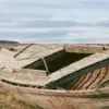 Color analog photograph of a deteriorating wooden boat resting on land along Puerto Natales Harbor in Patagonia, Chile.